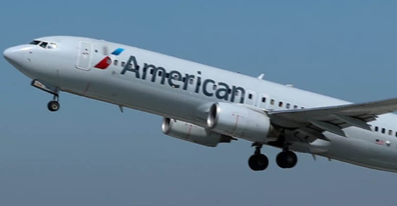 Picture of an American Airlines airplane returning patients home after having plastic surgery at Frontline Plastic Surgery in San Jose, Costa Rica.  The airplane is ascending and shows American Airlines new colors.